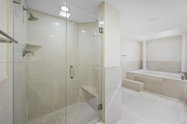 a bathroom with a bathtub and a shower