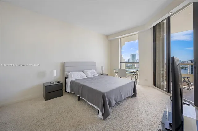 a spacious bedroom with a bed and a large window