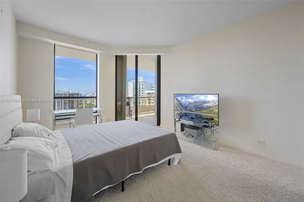 a bedroom with a bed a table and chair