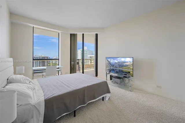 a bedroom with a bed a table and chair