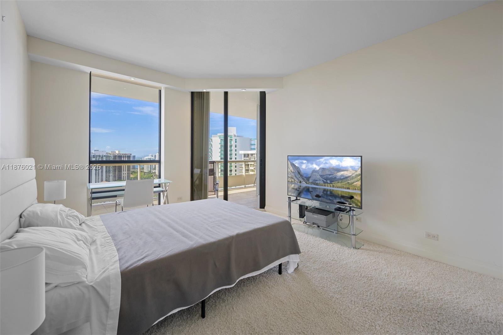 20191 East Country Club Drive, Unit TS8 Aventura, FL 33180 - Photo 16 of 27 a bedroom with a bed a table and chair