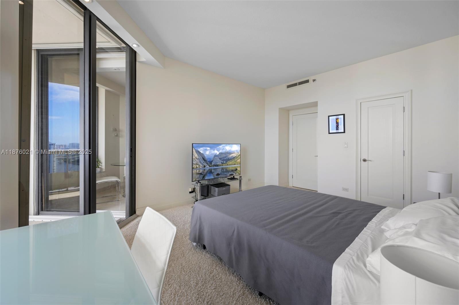 20191 East Country Club Drive, Unit TS8 Aventura, FL 33180 - Photo 17 of 27 a bedroom with a bed and a flat screen tv