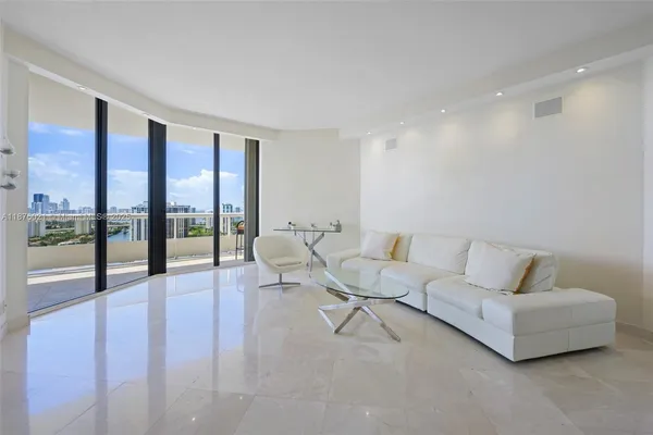 a living room with furniture and a floor to ceiling window