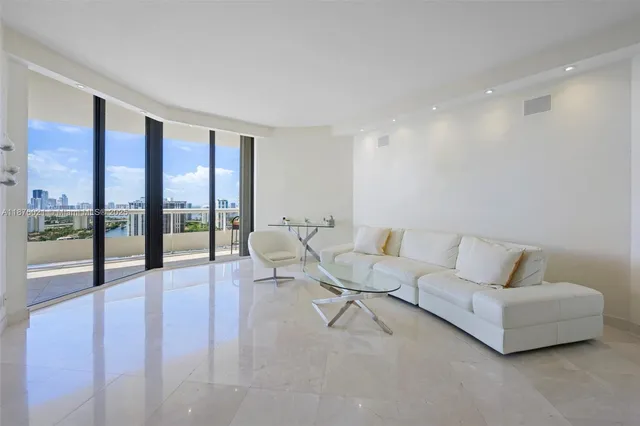 a living room with furniture and a floor to ceiling window