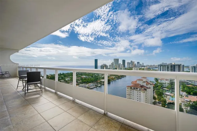 a view of a terrace with furniture and city view