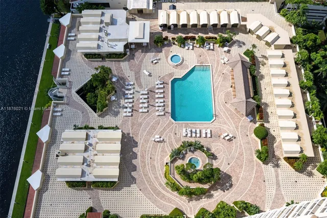 an aerial view of a house with a swimming pool and outdoor space