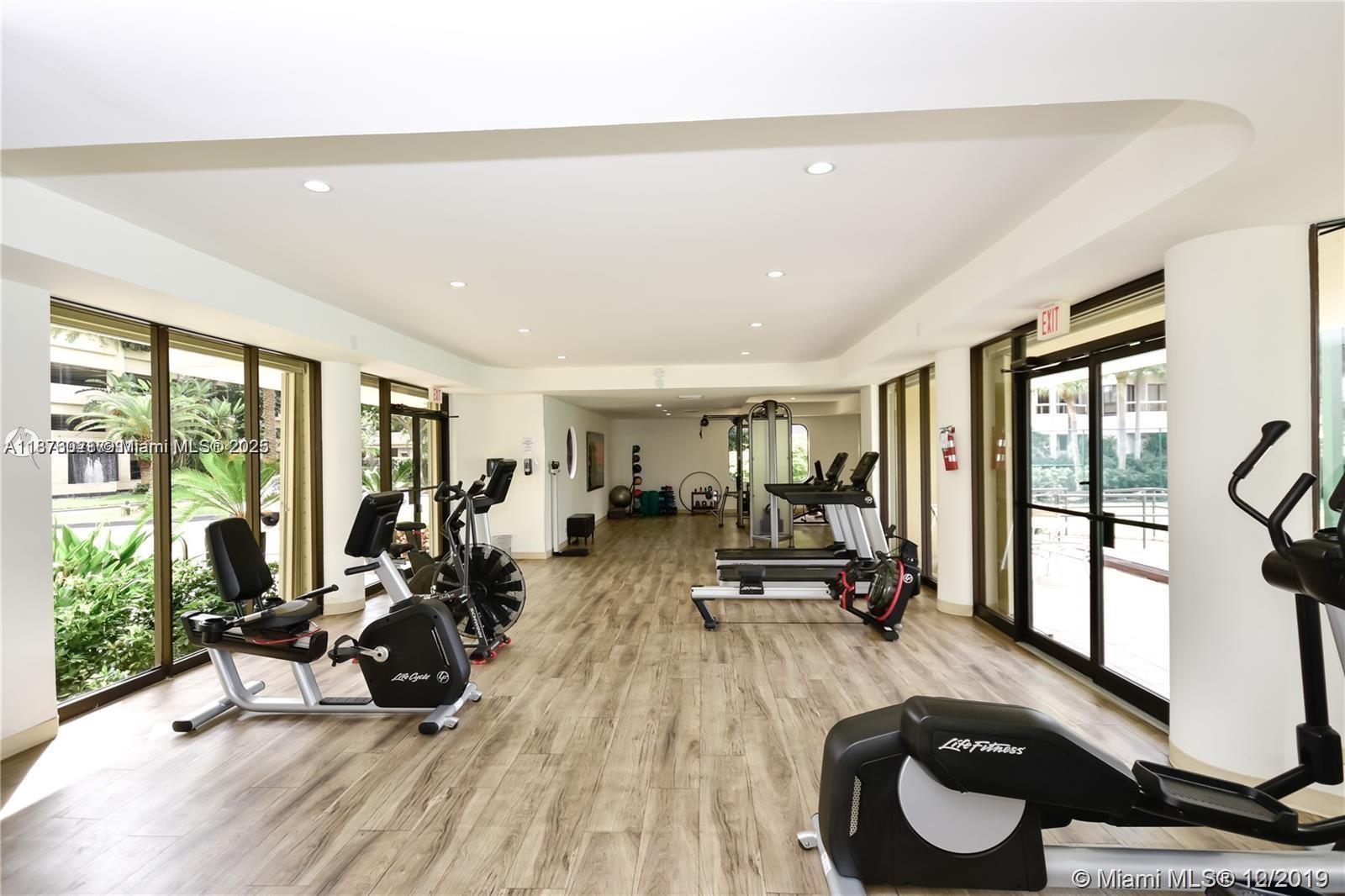20191 East Country Club Drive, Unit TS8 Aventura, FL 33180 - Photo 25 of 27 a view of a room with gym equipment and large windows