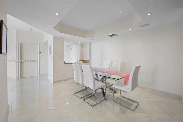 a living room with furniture and a dining table with wooden floor