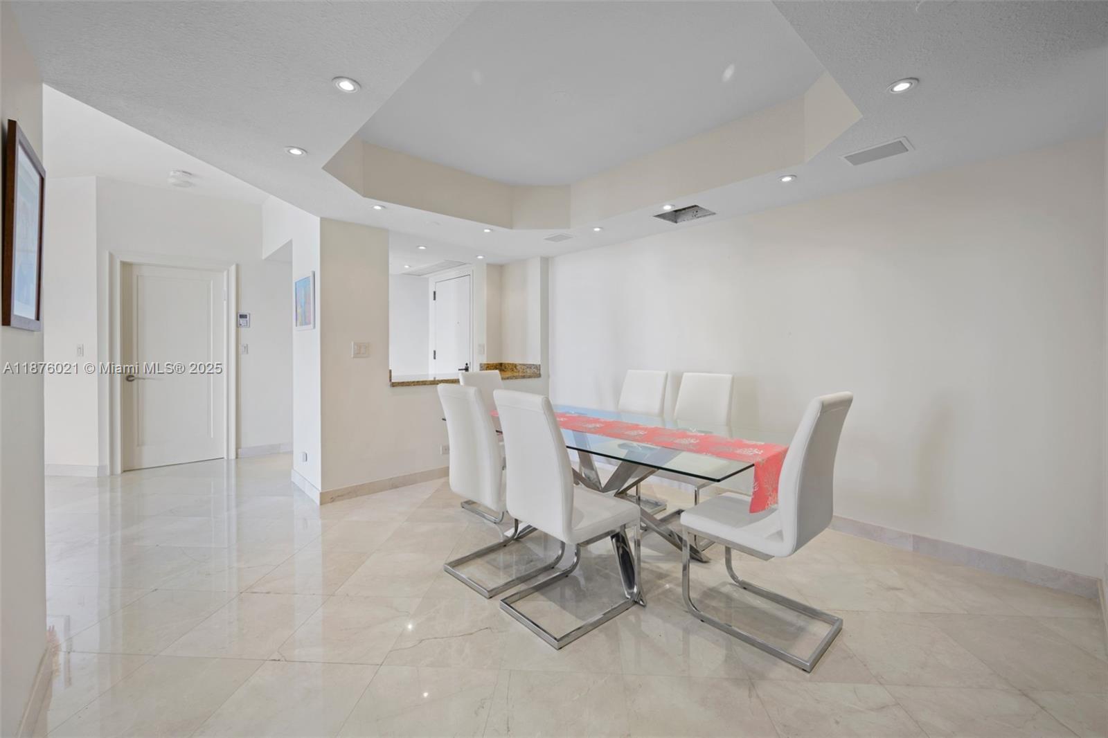 20191 East Country Club Drive, Unit TS8 Aventura, FL 33180 - Photo 4 of 27 a living room with furniture and a dining table with wooden floor