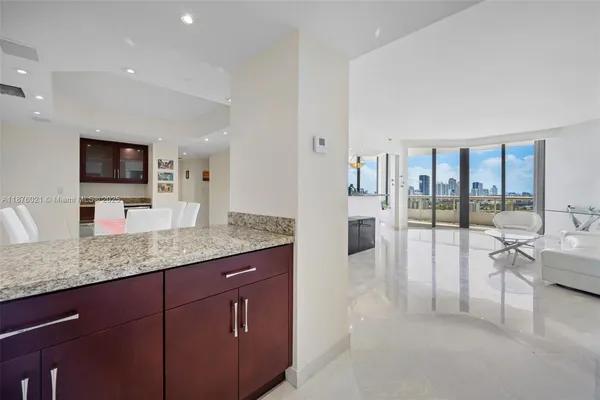 a spacious en suite bathroom with a granite countertop sink and a large mirror