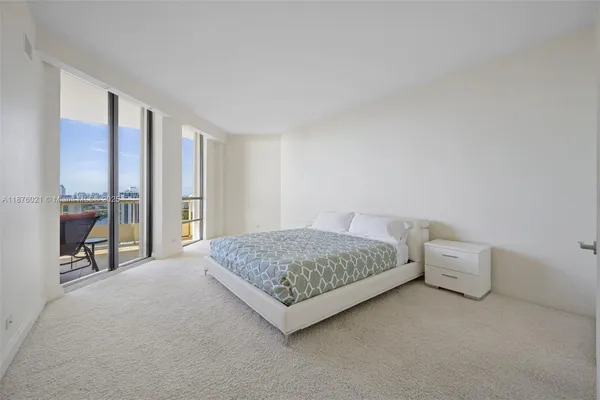 a living room with furniture and large windows