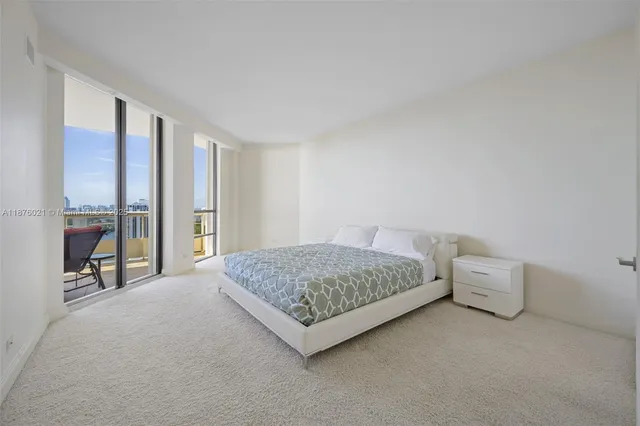 a living room with furniture and large windows