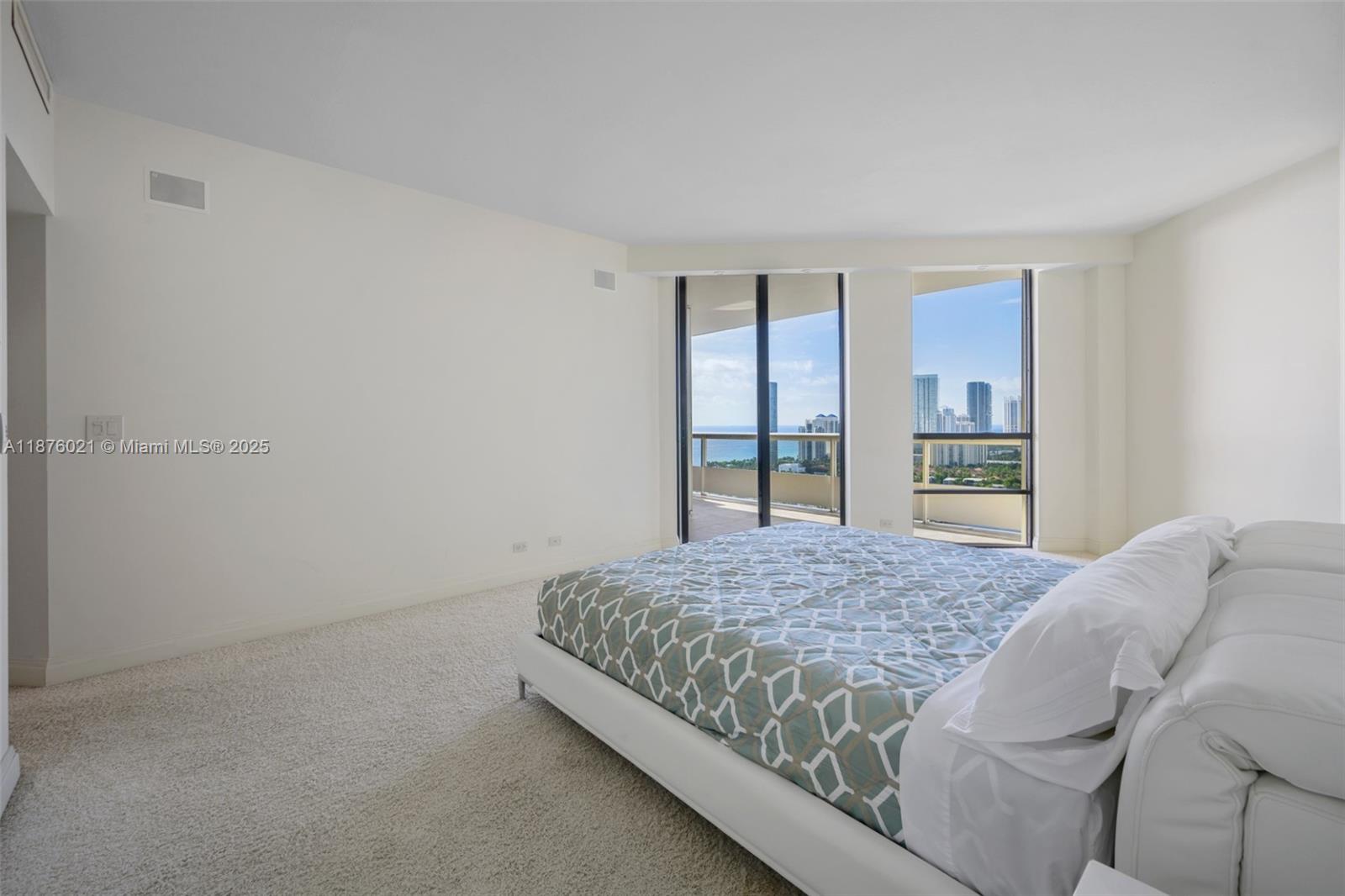 20191 East Country Club Drive, Unit TS8 Aventura, FL 33180 - Photo 10 of 27 a bedroom with a bed and a window