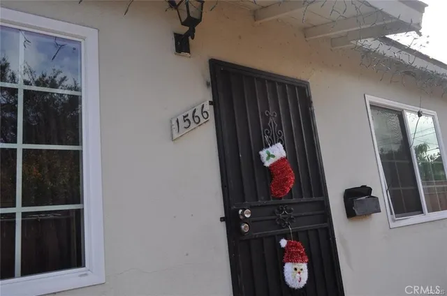 a view of a hallway with wooden floor and closet