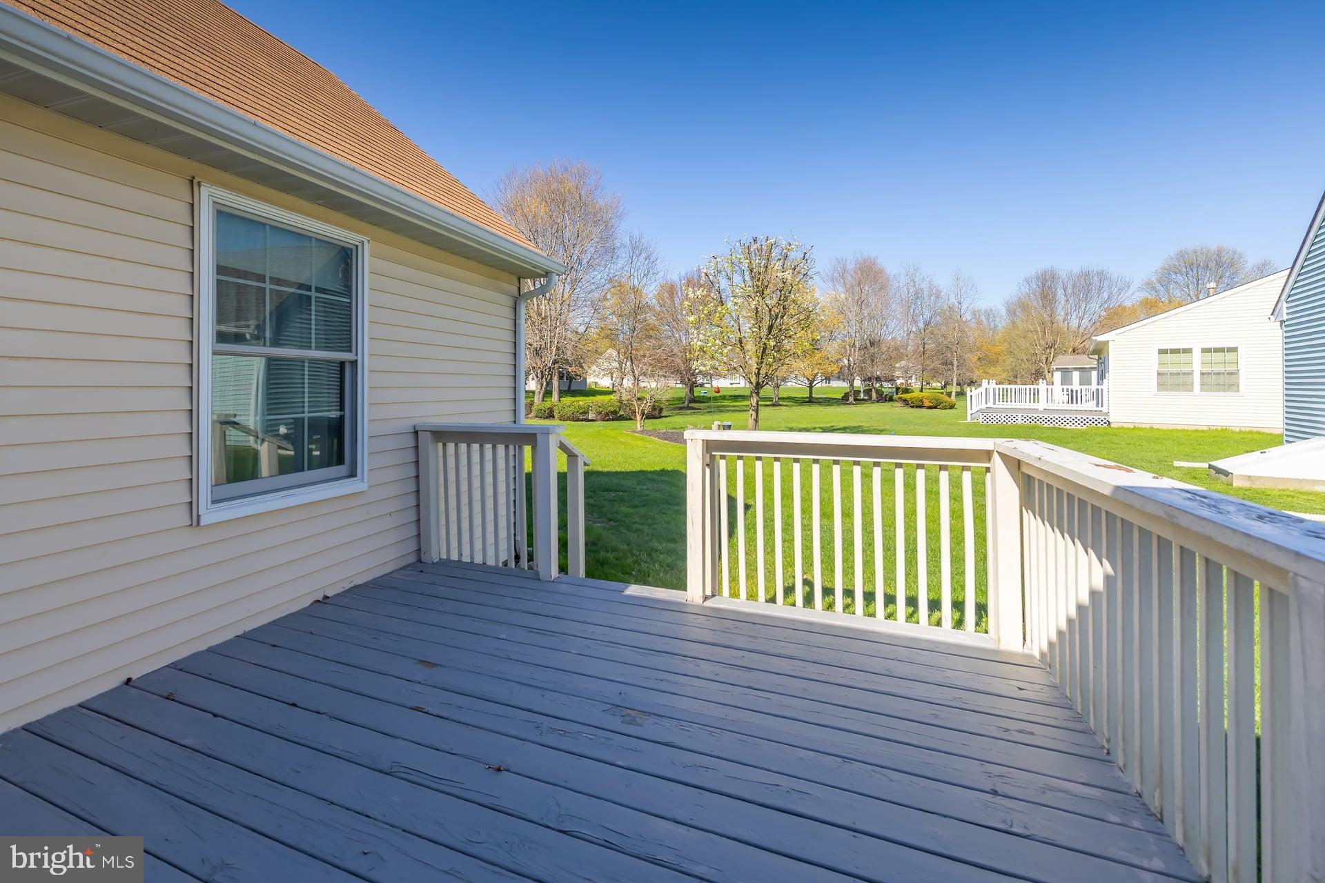 423 Country Way Mickleton, NJ 08056 - Photo 16 of 19 a view of a deck with large trees and wooden fence