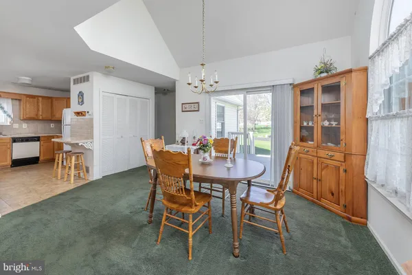 a dining room with furniture window and wooden floor