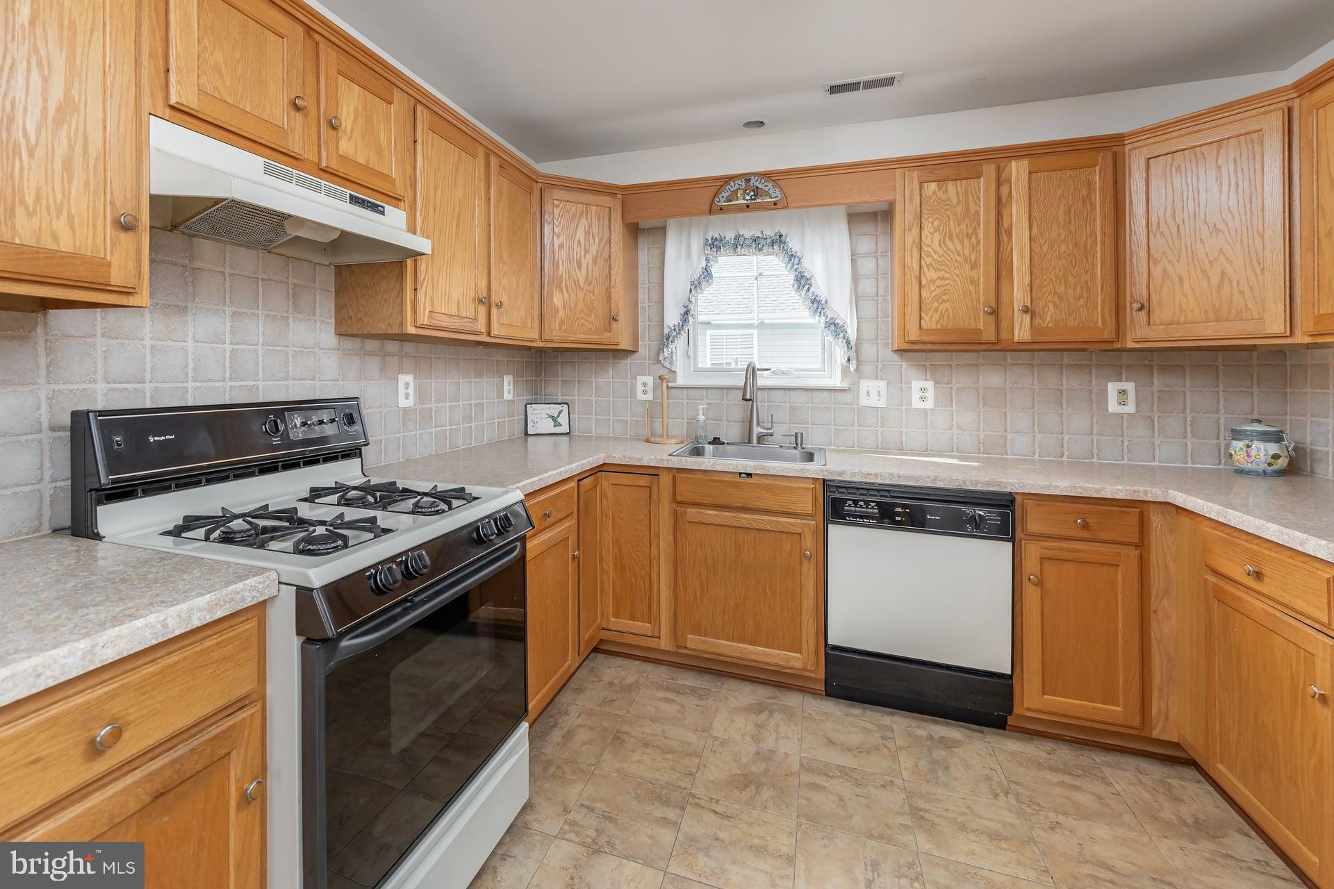 423 Country Way Mickleton, NJ 08056 - Photo 8 of 19 a kitchen with a sink stove and cabinets