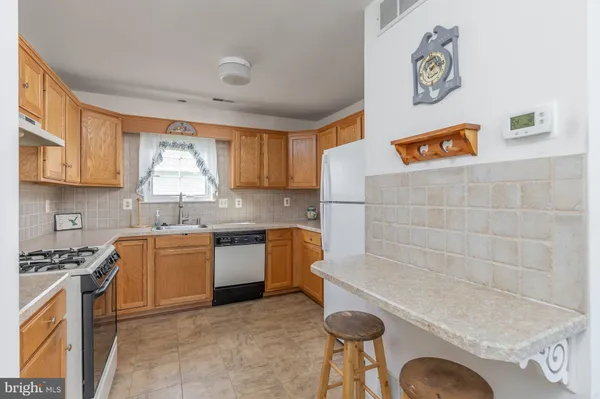a kitchen with stainless steel appliances granite countertop a sink and a stove top oven