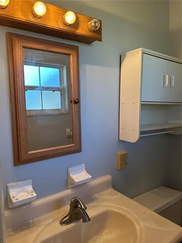 a bathroom with a sink and a mirror