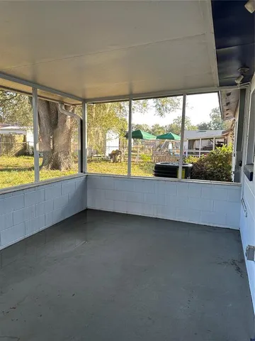 wooden floor in an empty room with a large window