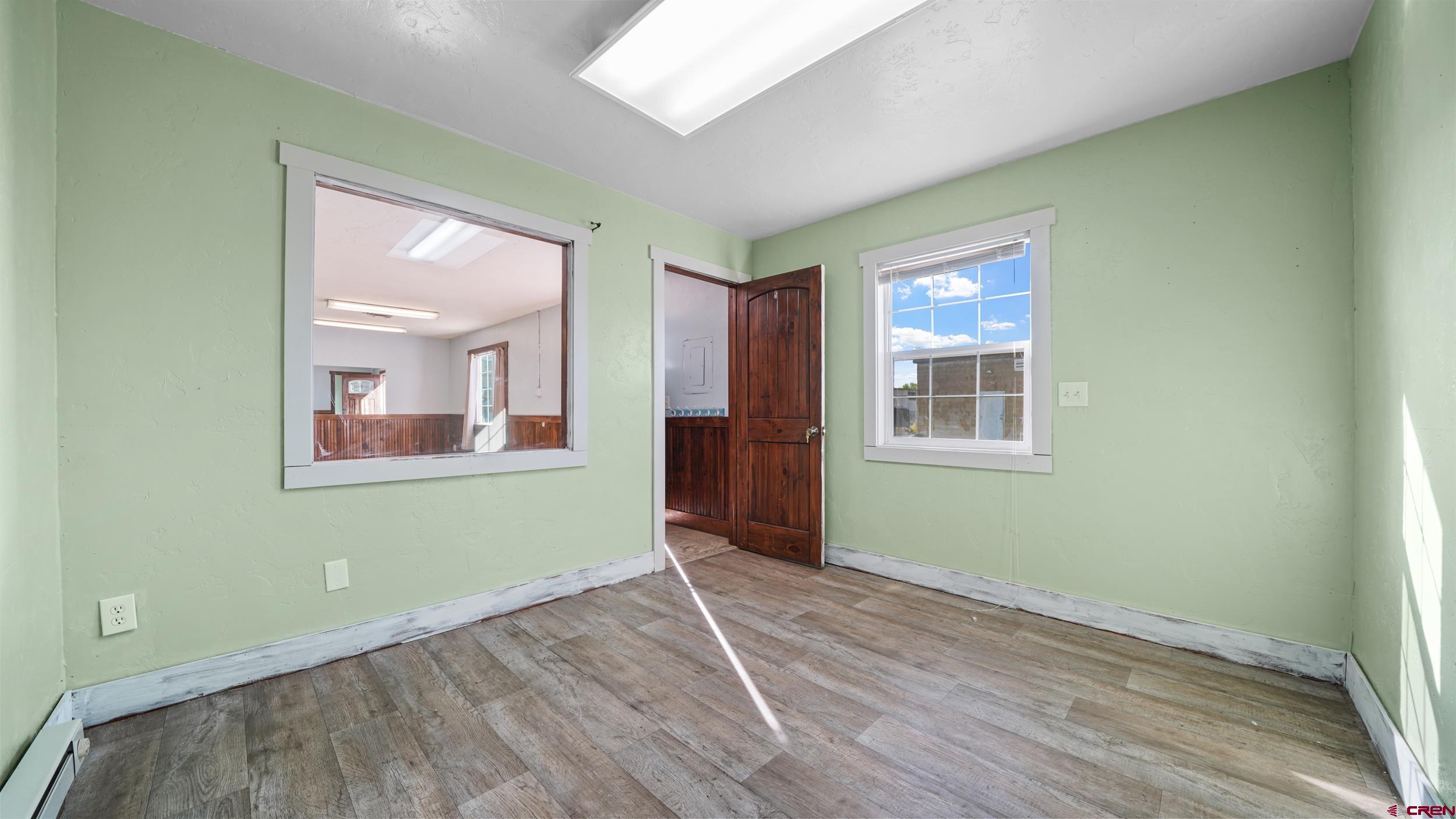 743 Highway 6&50 Fruita, CO 81521 - Photo 22 of 26 an empty room with wooden floor and windows