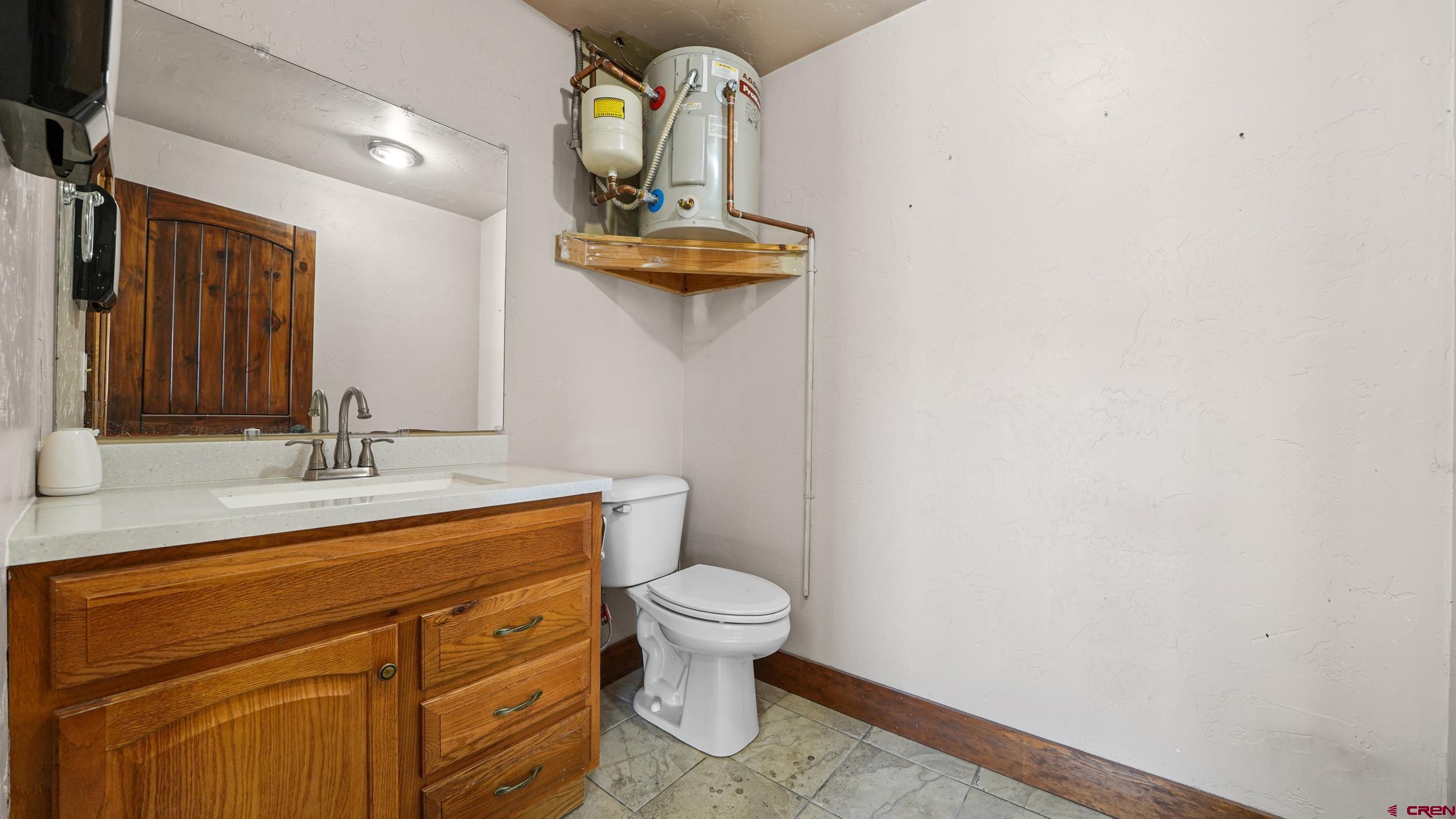 743 Highway 6&50 Fruita, CO 81521 - Photo 23 of 26 a bathroom with a toilet a sink and mirror