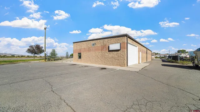 a view of a house with a backyard and garden