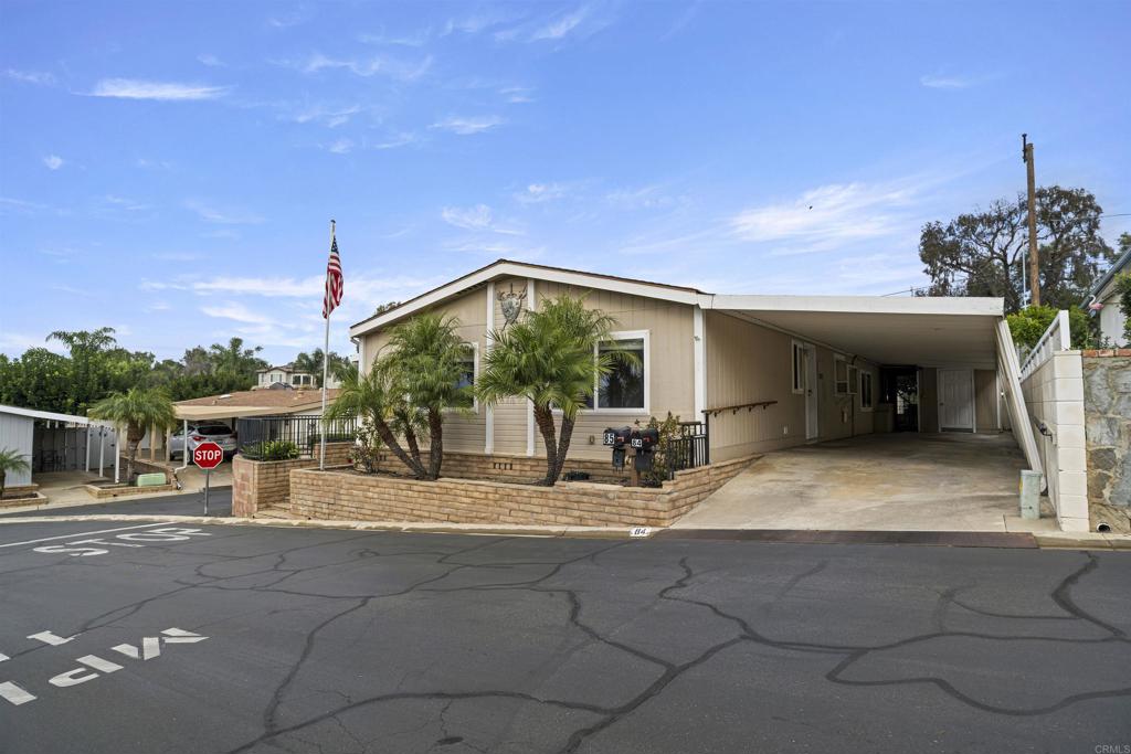 a view of a house with porch and chairs