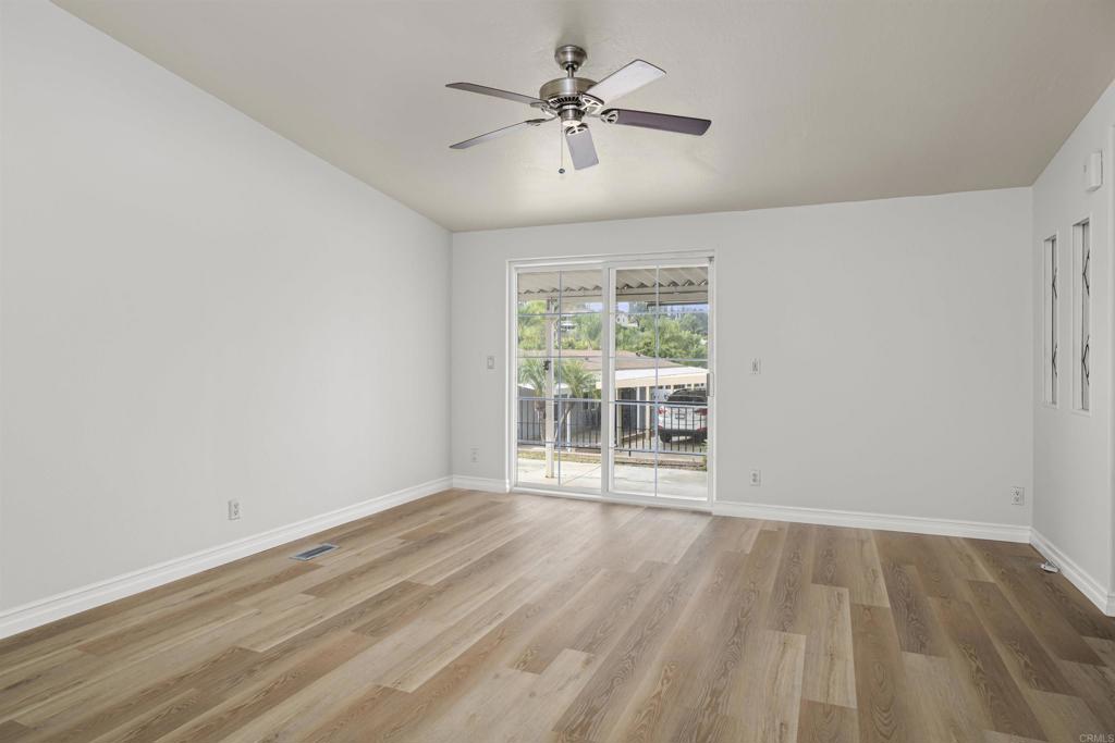 909 Richland Road, Unit 84 San Marcos, CA 92069 - Photo 15 of 35 wooden floor in an empty room with a window