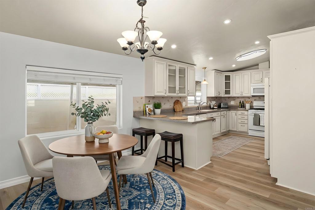 909 Richland Road, Unit 84 San Marcos, CA 92069 - Photo 16 of 35 a kitchen with a dining table chairs and refrigerator