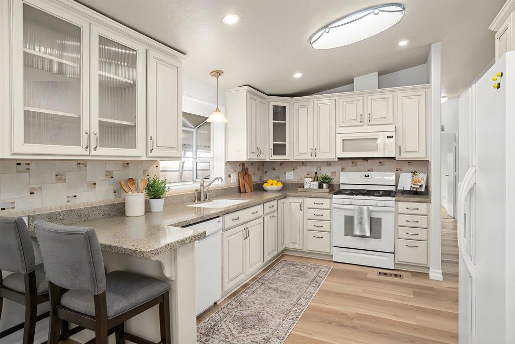 909 Richland Road, Unit 84 San Marcos, CA 92069 - Photo 18 of 35 a kitchen with stainless steel appliances granite countertop a sink and cabinets
