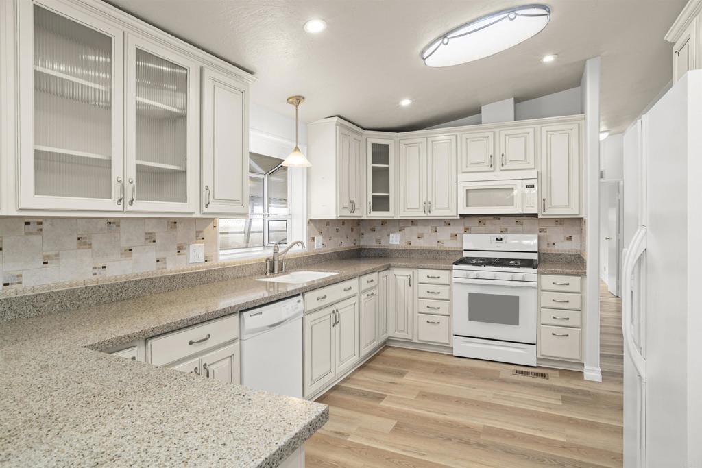 909 Richland Road, Unit 84 San Marcos, CA 92069 - Photo 19 of 35 a kitchen with stainless steel appliances granite countertop a stove a sink and white cabinets