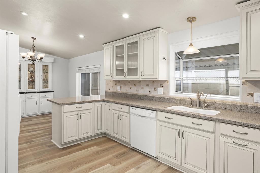 909 Richland Road, Unit 84 San Marcos, CA 92069 - Photo 20 of 35 a kitchen with granite countertop white cabinets white appliances and sink