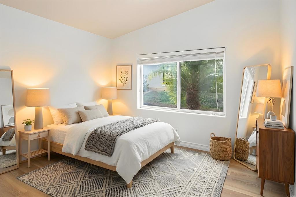 909 Richland Road, Unit 84 San Marcos, CA 92069 - Photo 28 of 35 a bedroom with a bed and wooden floor