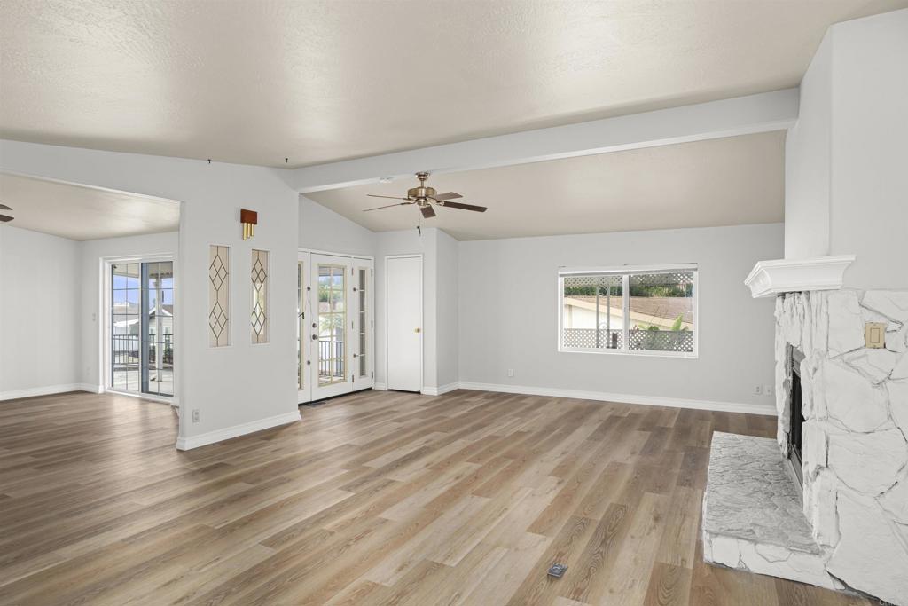 909 Richland Road, Unit 84 San Marcos, CA 92069 - Photo 6 of 35 a view of an empty room with wooden floor and a window