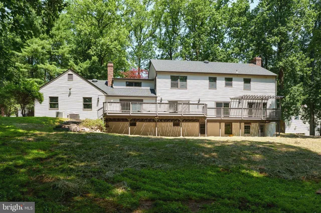 a front view of a house with a garden and trees
