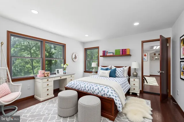 a bedroom with a bed and a large window