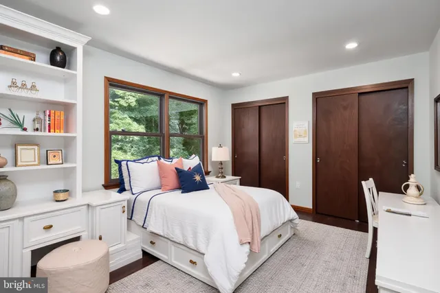 a bedroom with a large bed and a window