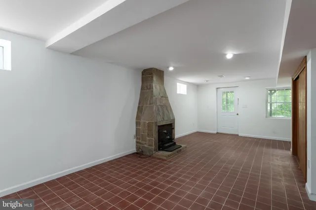 an empty room with entrance and windows