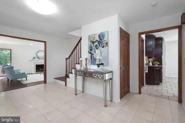 a view of an entryway with dining table and chairs