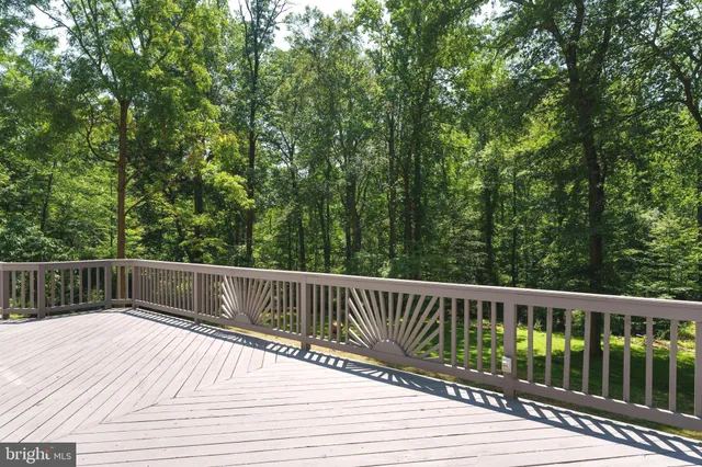 a balcony with wooden floor and fence