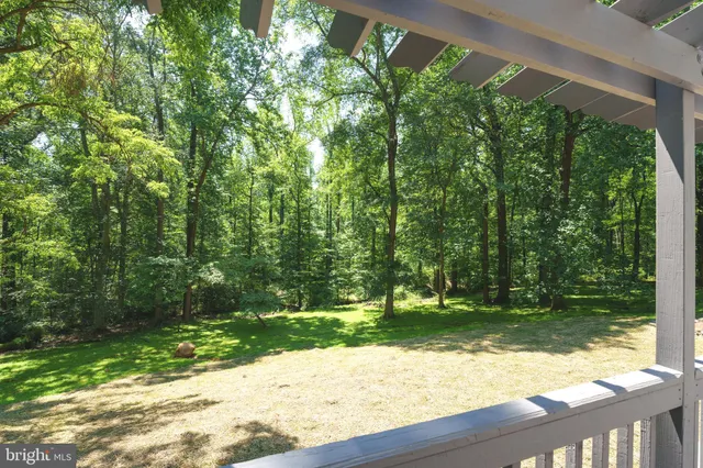 a wooden fence with trees in the background