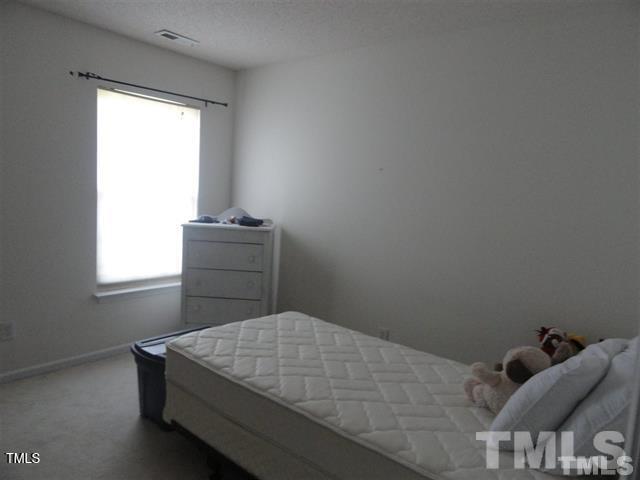308 Durston Loop Morrisville, NC 27560 - Photo 3 of 13 a bedroom with a bed and window