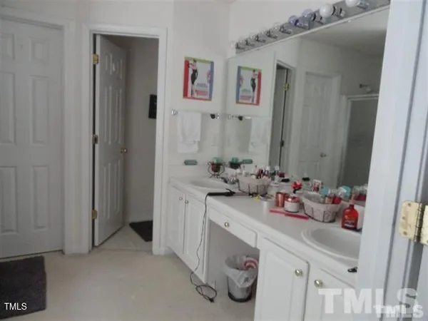 a bathroom with a sink mirror and vanity