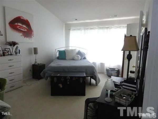 a bedroom with furniture and a flat tv screen