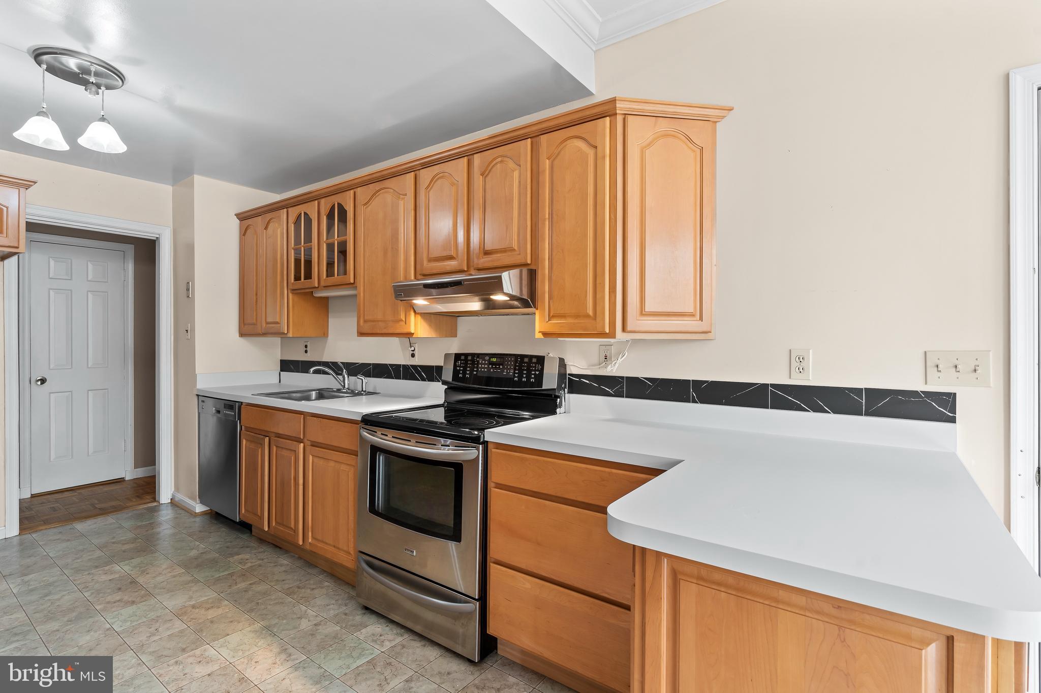 7705 Ridge Road Frederick, MD 21702 - Photo 14 of 51 a kitchen with a stove a sink and a refrigerator