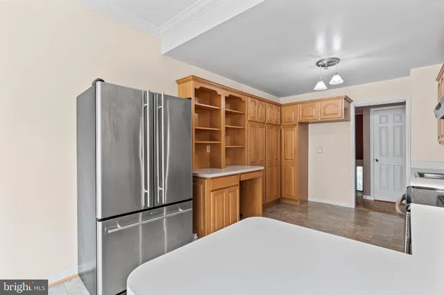 a kitchen with stainless steel appliances a refrigerator and microwave