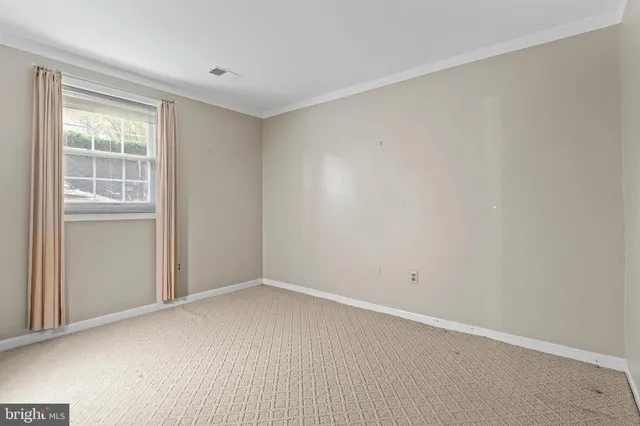 a view of an empty room with closet area