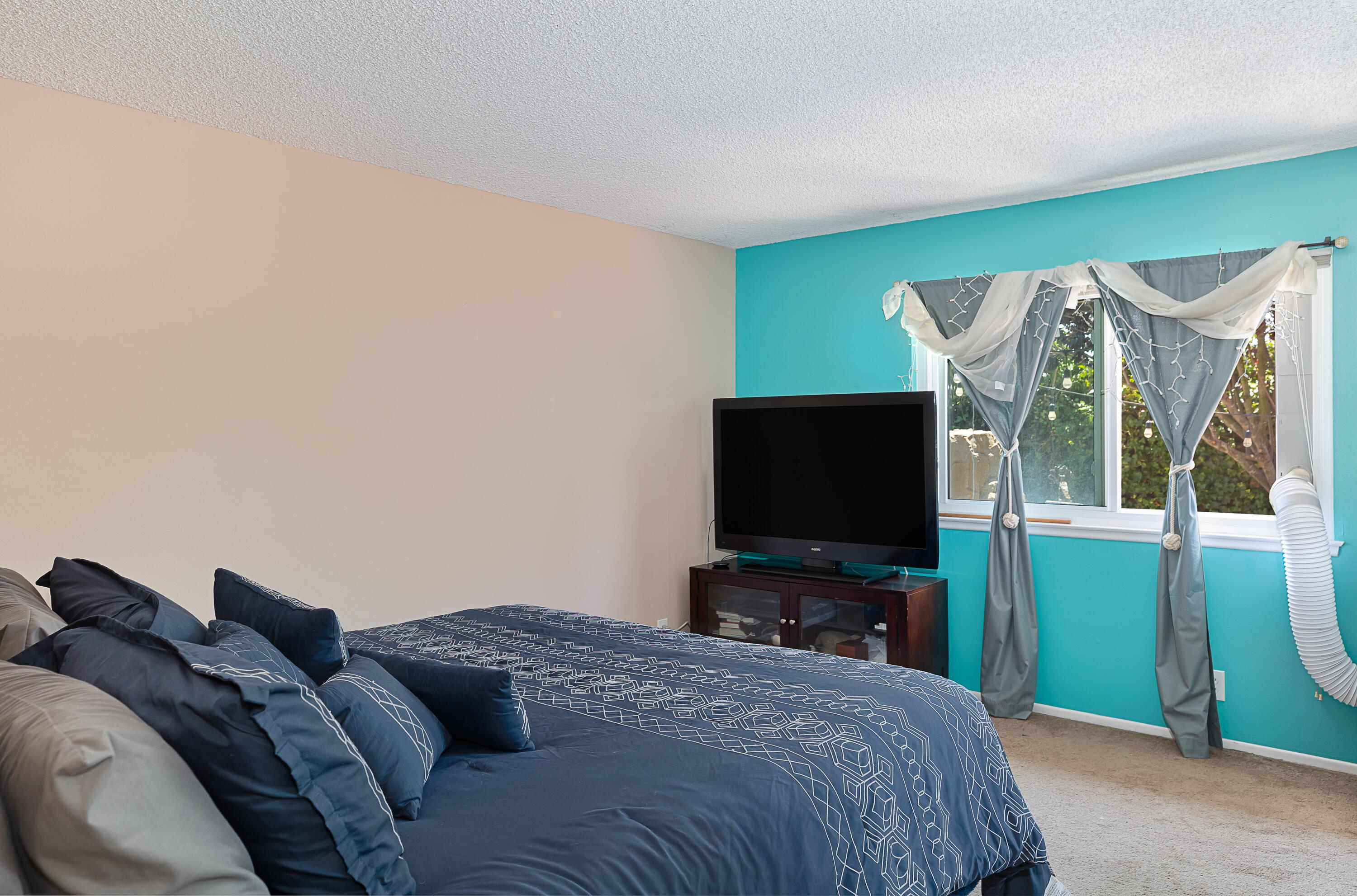 224 Hillview Drive Goleta, CA 93117 - Photo 11 of 20 a bedroom with a bed and a flat screen tv