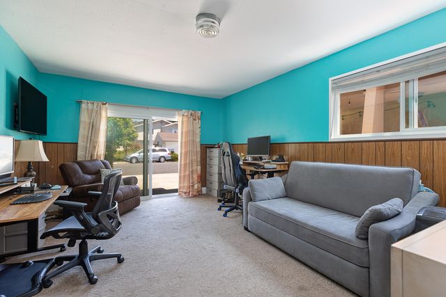 a workspace with lounge chair and a window